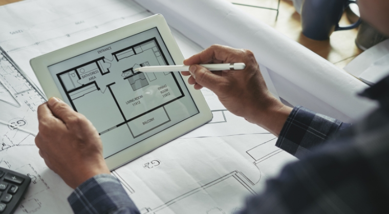 Architect looks at floorplan on tablet